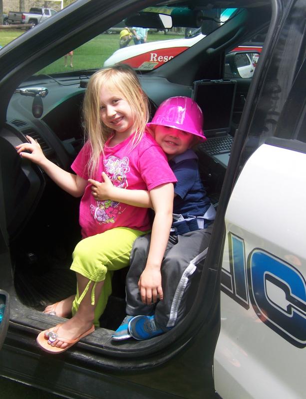 Olivia Govoni and her brother Harrison of Marion check out squad car at the touch a truck event. BY MATTHEW BERNAT
